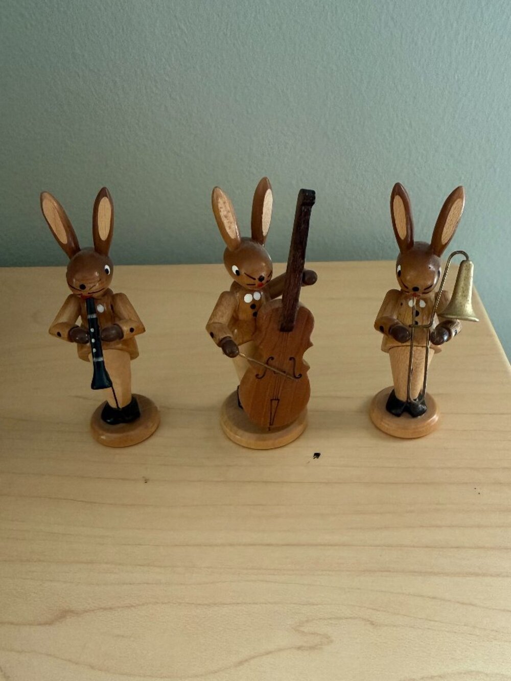Three Erzgebirge natural wood rabbits with instruments
